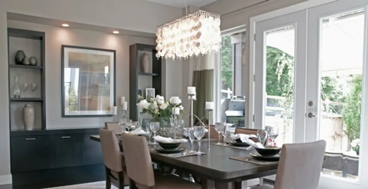 Elegant dining room chandelier installation above table in Minneapolis, MN