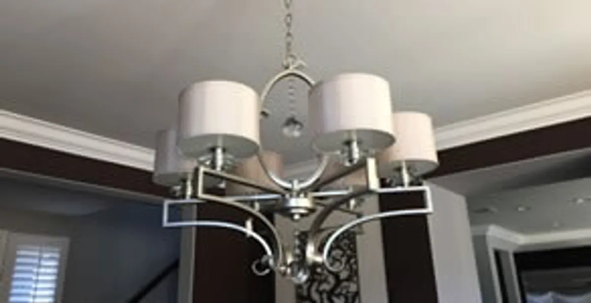 Modern chandelier installation with multiple light fixtures in Minneapolis, MN
